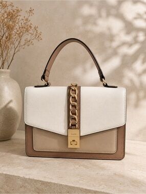 ALDO women's handbag with a top handle and chain detail.